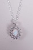 A 925 silver pendant necklace set with an opalite encircled by cubic zirconium, 1" drop