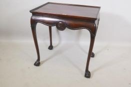 A C19th mahogany silver table, with dished top and carved and shaped frieze, raised on cabriole