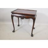 A C19th mahogany silver table, with dished top and carved and shaped frieze, raised on cabriole