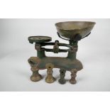 A set of Boots iron kitchen scales with brass pan and four brass bell weights