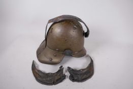 A C19th brass fireman's helmet, A/F, 12" long