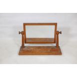 An Arts and Crafts oak swing toilet mirror, 10" x 30" x 20"