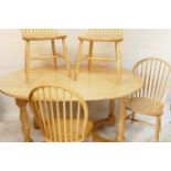 A beechwood dining table with oval top and four hoop back chairs, 41" x 62"