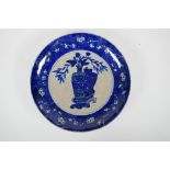 A Chinese early C20th blue and white crackleware charger decorated with objects of virtu within a