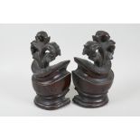 Two well carved mahogany terminals, 8" high