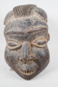 An African carved wood mask, 14" high