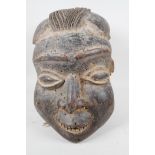 An African carved wood mask, 14" high