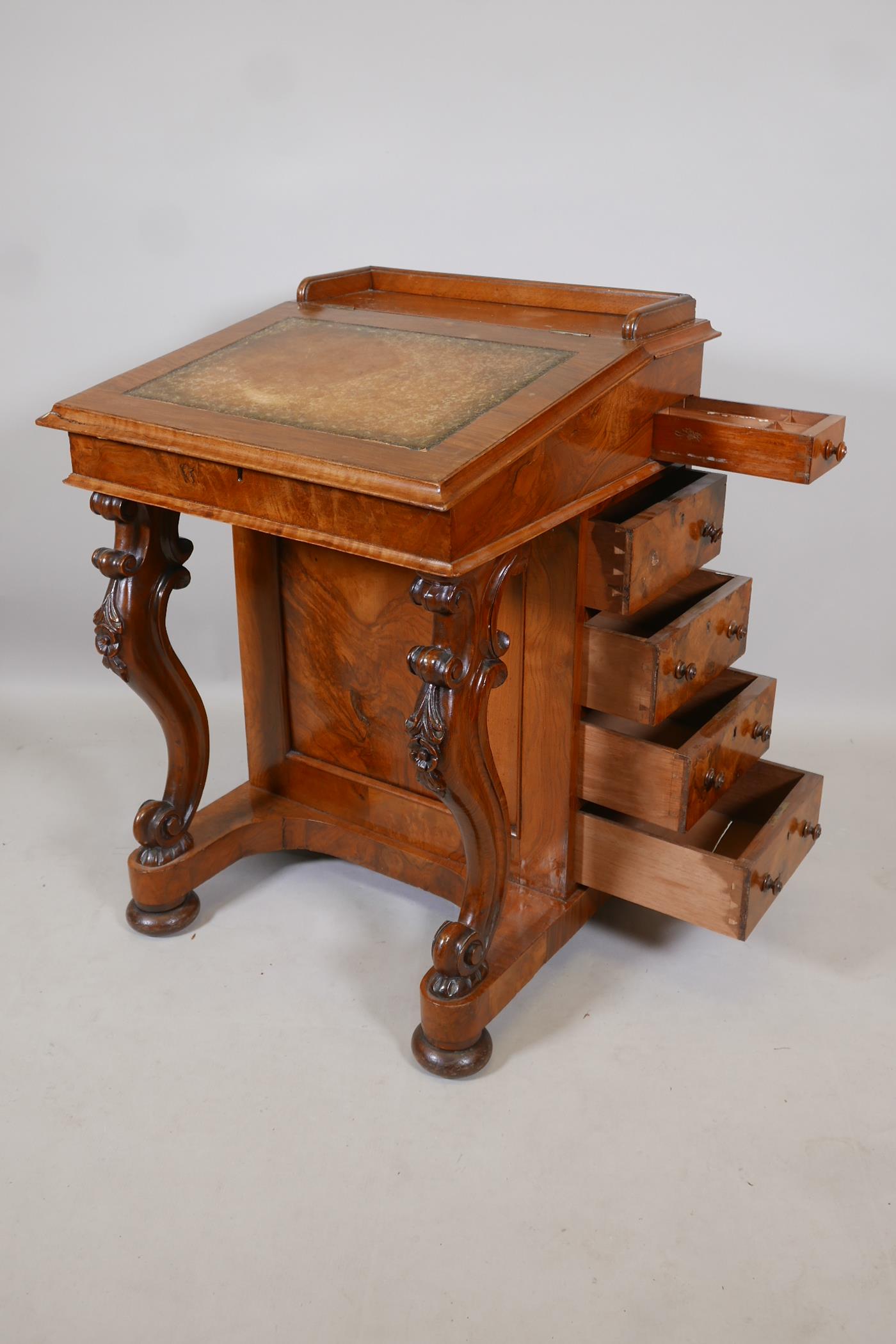 A Victorian figured walnut davenport with carved piano legs, tooled leather inset top and fitted - Image 8 of 9