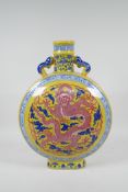 A Chinese yellow ground porcelain two handled moon flask with blue, white and red dragon decoration,