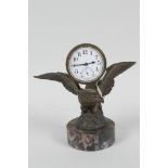 A desk clock cast as an eagle with spread wings, mounted on a marble plinth, 5" high