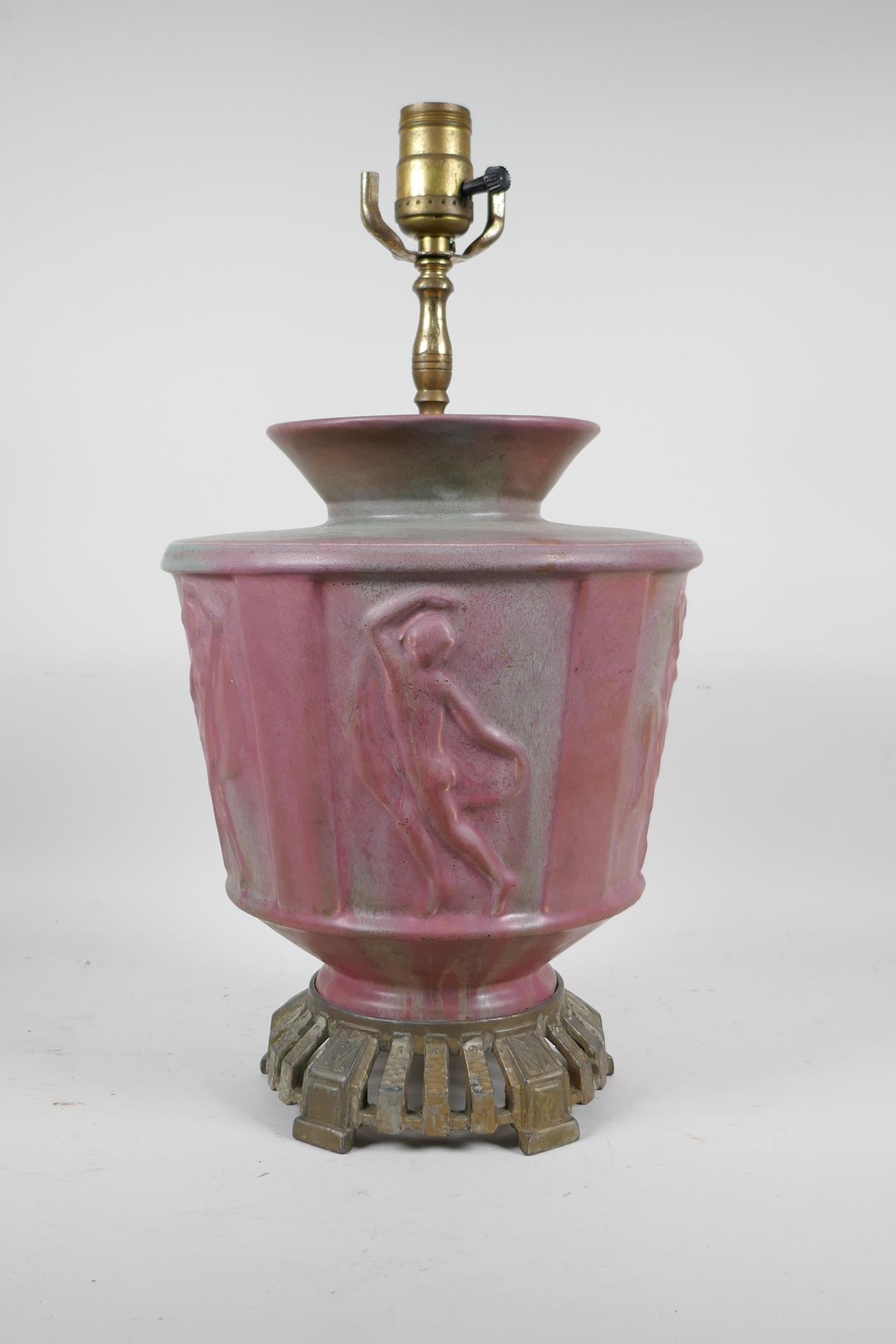 A pink glazed ceramic lamp with metal mounts, the body decorated with classical nudes, 17" high