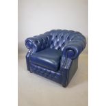 A blue leather buttoned club chair in the Chesterfield style, 31" high x 40" wide