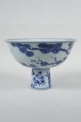 A Chinese blue and white porcelain stem bowl with cypress tree, prunus blossom and bamboo