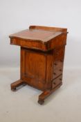 A Victorian walnut davenport with four drawers and four dummy drawers, three quarter gallery and