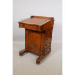 A Victorian walnut davenport with four drawers and four dummy drawers, three quarter gallery and