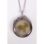 A silver and agate pendant necklace decorated with a goat and Chinese symbols, 2" drop