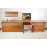 A 1970s modular teak topped dressing table with six drawers, and a matching single drawer bedside