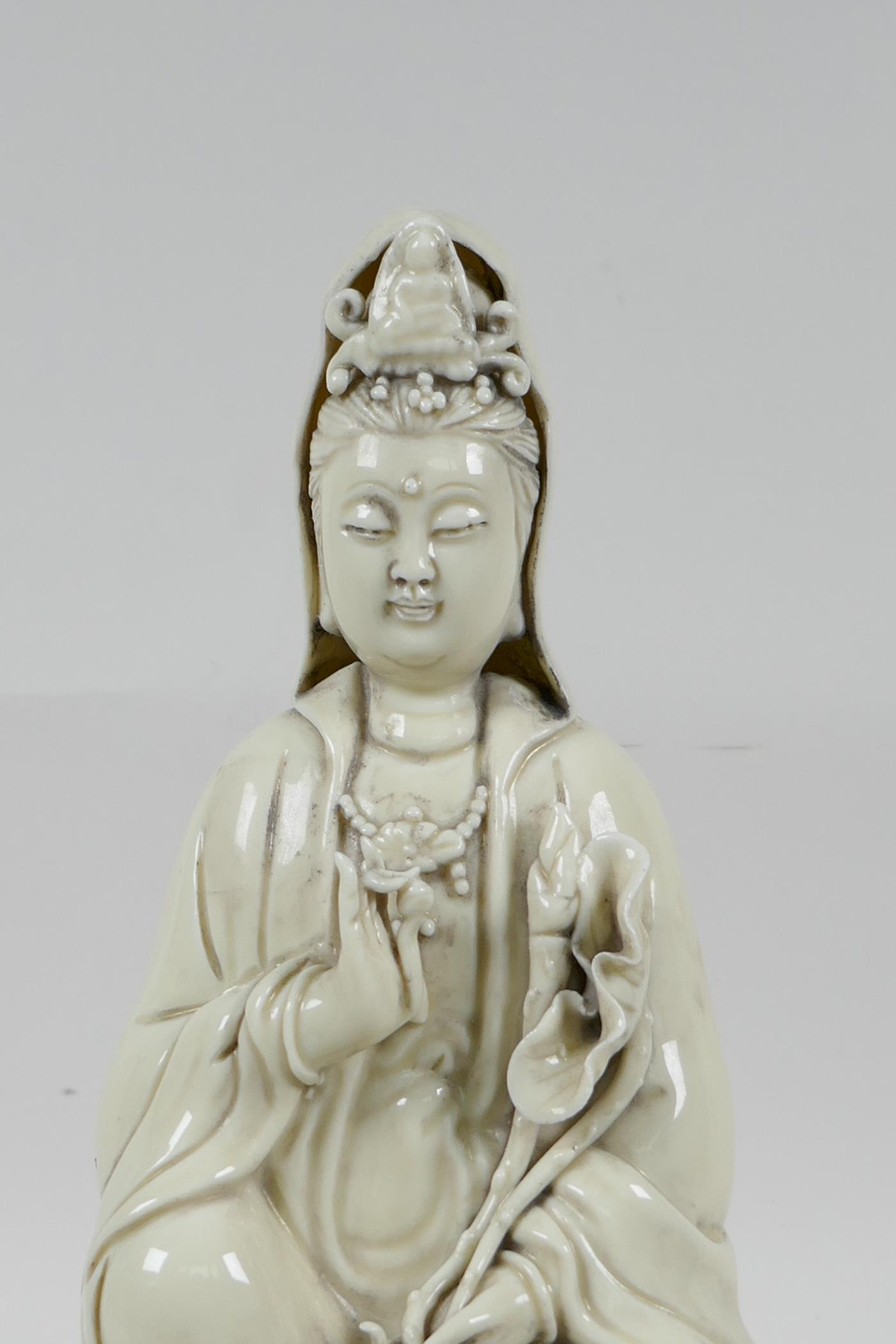 A Chinese blanc de chine porcelain Quan Yin seated on a lotus throne, impressed marks verso, 10½" - Image 3 of 6