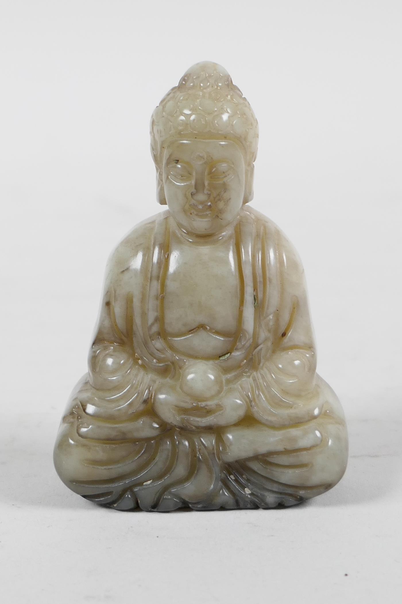 A Chinese mottled hardstone carving of Buddha, 2½" high