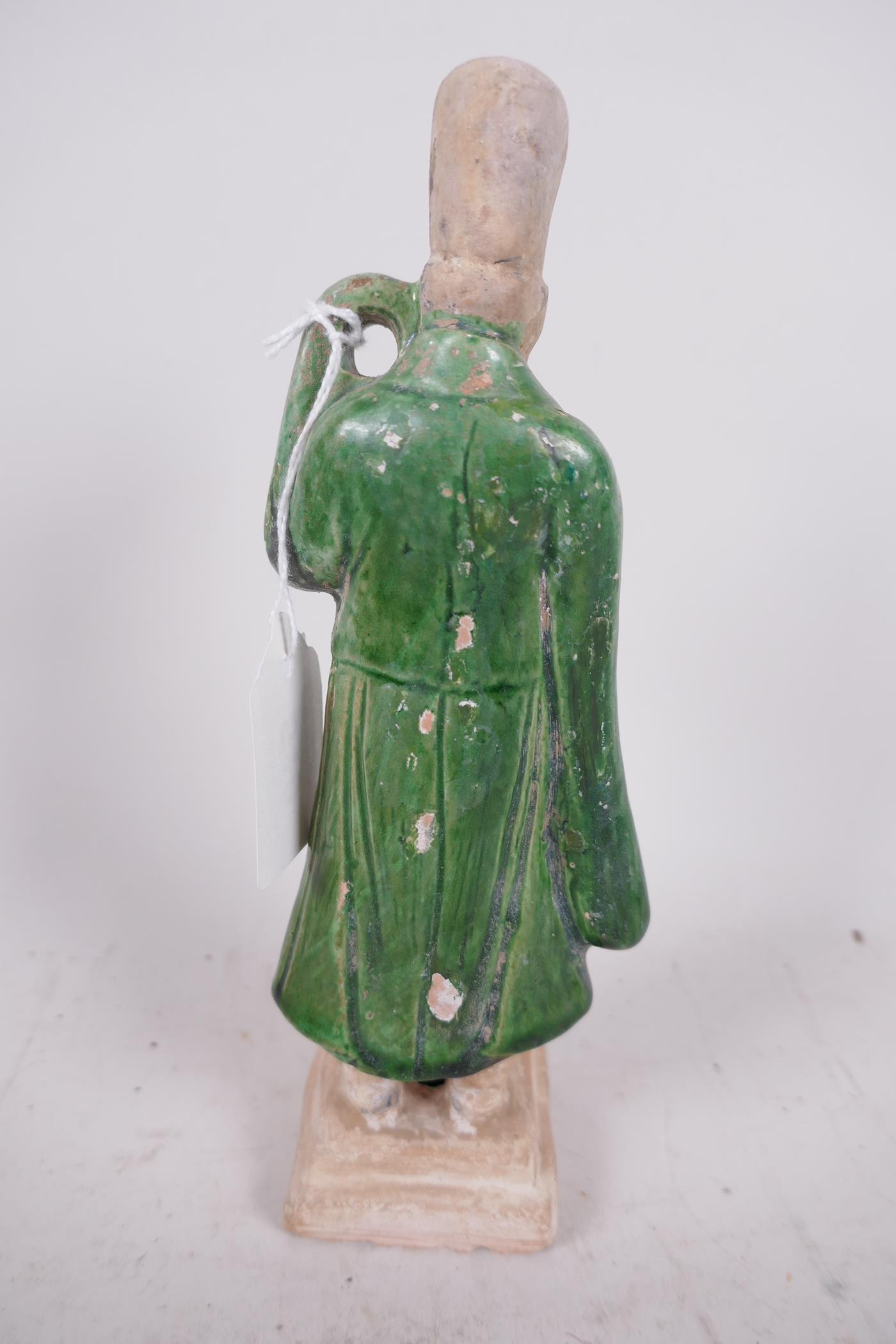A Chinese Tang dynasty (618-907AD) terracotta figure of a standing male court attendant, Sancai - Image 4 of 4