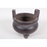 A Chinese bronze two handled cauldron shaped censer, 4" diameter