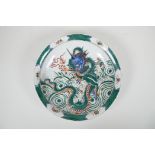 A Chinese famille verte porcelain charger decorated with a dragon and the flaming pearl, 6 character