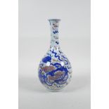 A Chinese blue, white and red porcelain bottle vase with a flared rim, decorated with a kylin with a