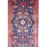 A rich blue ground full pile Persian Sarouk runner with an unique floral pattern, 122" x 41"