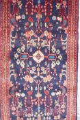 A rich blue ground full pile Persian Sarouk runner with an unique floral pattern, 122" x 41"