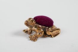 A miniature coppered metal pincushion in the form of a frog