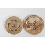 A Chinese carved faux horn pi disc pendant with twin kylin decoration, and a hardstone pi disc