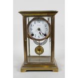 An American brass and glass mantel clock by 'Ansonia Clock Co.', the movement striking on a gong,