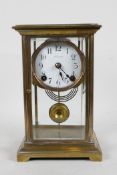 An American brass and glass mantel clock by 'Ansonia Clock Co.', the movement striking on a gong,