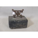 An antique wrought iron bootscraper mounted on a painted stone base, 12" x 8" x 13"