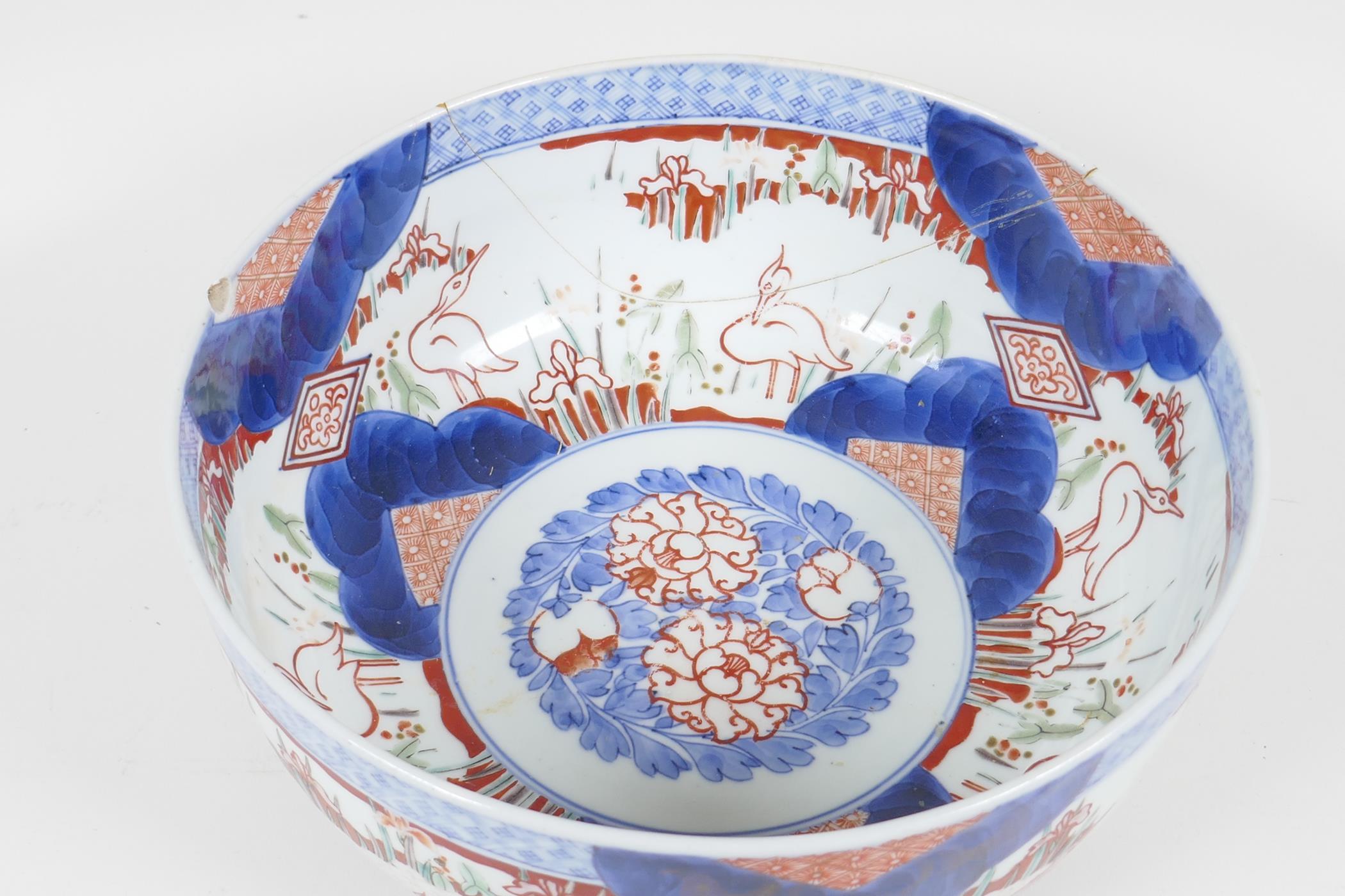 A C19th Japanese Imari porcelain bowl painted with herons amongst the reeds, in traditional colours, - Image 2 of 6