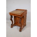 A Victorian figured walnut davenport with carved piano legs, tooled leather inset top and fitted