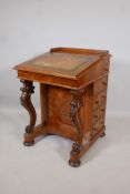 A Victorian figured walnut davenport with carved piano legs, tooled leather inset top and fitted