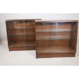 A pair of mahogany waterfall display cabinets with glass shelves and doors, mid C20th, 36" x 14" x
