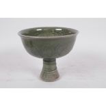 A Chinese dark green jade celadon stem cup decorated with dragons and fish, 5" high