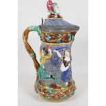 A C19th Minton majolica tower jug with pewter rimmed lid decorated with dancing figures, the lid