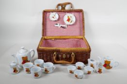 A child's 'Teddy Bear's Picnic' hamper containing a porcelain part tea and coffee set, 12" x 9" x