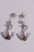 A pair of silver earrings in the form of anchors, 1" drop