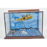 An RAF helicopter rescue diorama, glass cased, 15½" wide