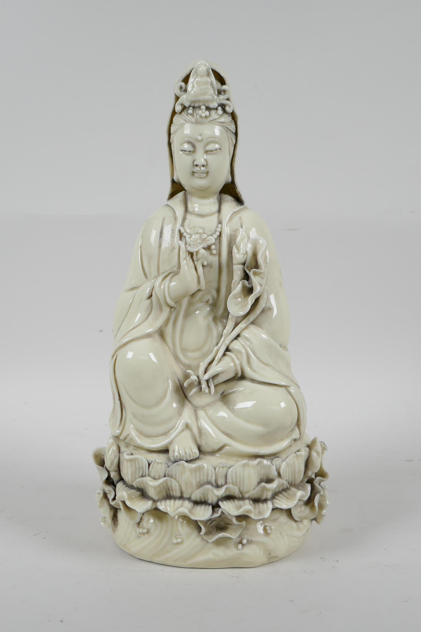 A Chinese blanc de chine porcelain Quan Yin seated on a lotus throne, impressed marks verso, 10½" - Image 2 of 6
