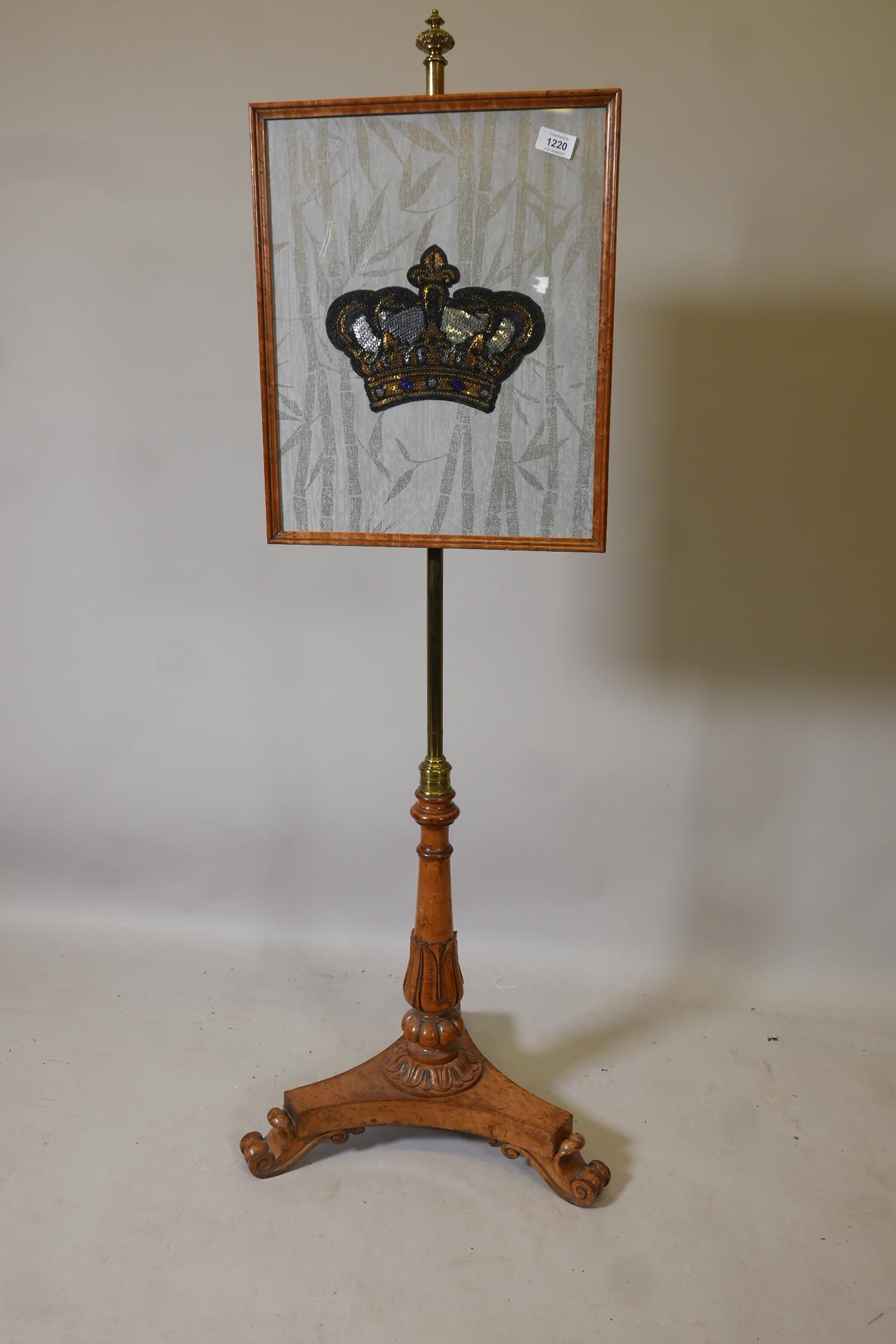 A Victorian bird's eye maple polescreen, with carved column and triform platform base with scroll