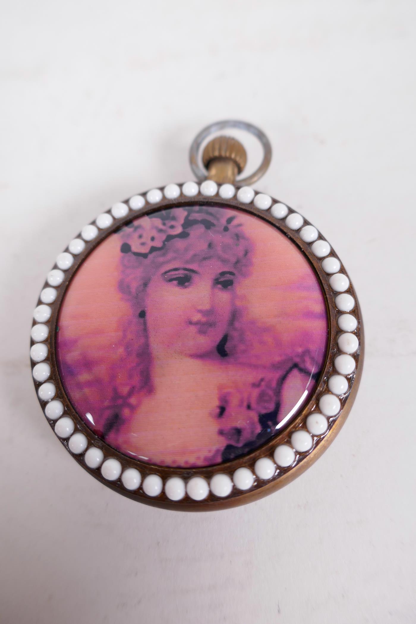 A replica top wind pocket watch set with a ring of pearl beads front and back, the back decorated - Image 2 of 2