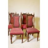 A set of four C19th walnut Art Nouveau high back chairs with shaped splats and carved back rails,