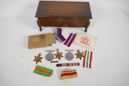 A collection of five medals from the Second World War; the Defence Medal, Africa Star, Italy Star