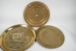 A Chinese brass tray with engraved decoration of a dragon, 14" diameter, together with another