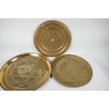 A Chinese brass tray with engraved decoration of a dragon, 14" diameter, together with another